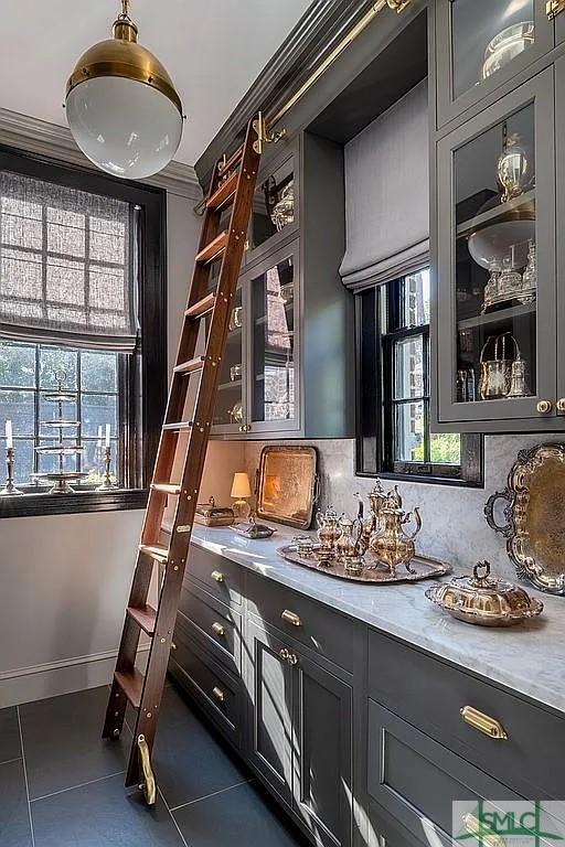 interior space with crown molding, dark tile patterned floors, and decorative backsplash