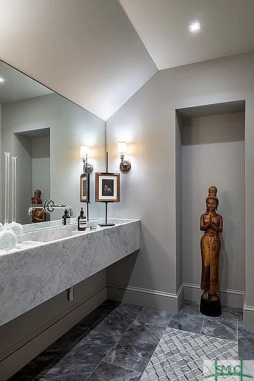 bathroom featuring vaulted ceiling