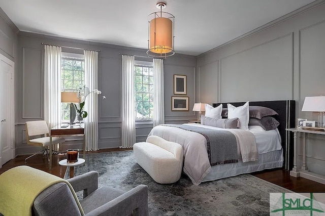 bedroom featuring crown molding and dark hardwood / wood-style floors