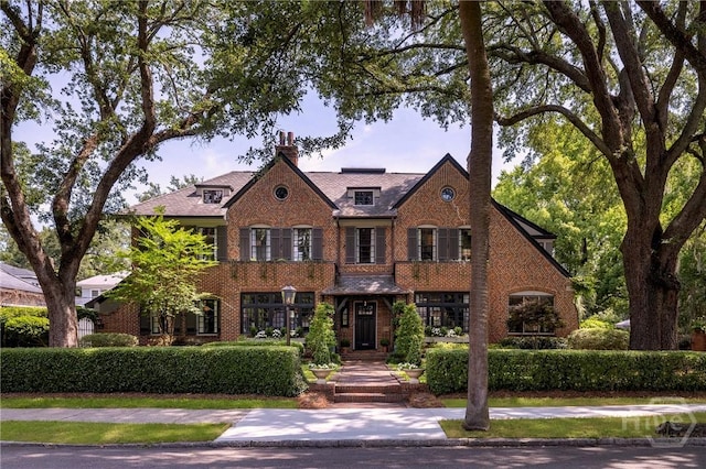 56 E 54th St, Savannah, GA 31405 - view of front of home with a chimney and brick siding