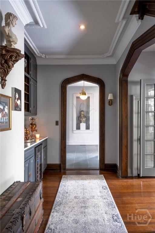 56 E 54th St, Savannah, GA 31405 - foyer entrance featuring wine cooler, crown molding, bar area, and dark wood-type flooring