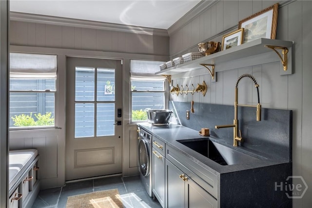 56 E 54th St, Savannah, GA 31405 - laundry area with crown molding, light tile patterned floors, and cabinet space
