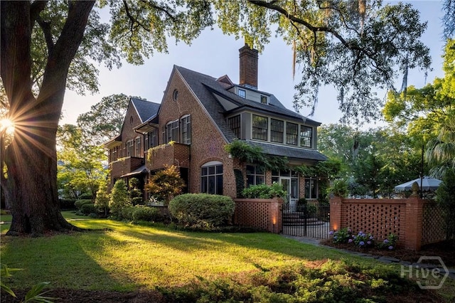 56 E 54th St, Savannah, GA 31405 - view of home's exterior featuring brick siding, a chimney, and a shingled roof
