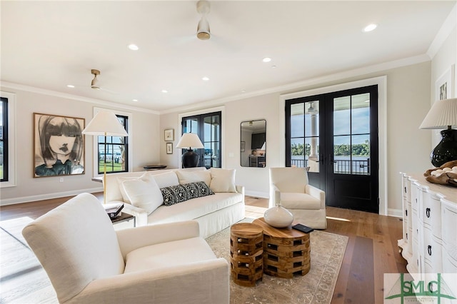 living room featuring crown molding, french doors, and hardwood / wood-style flooring