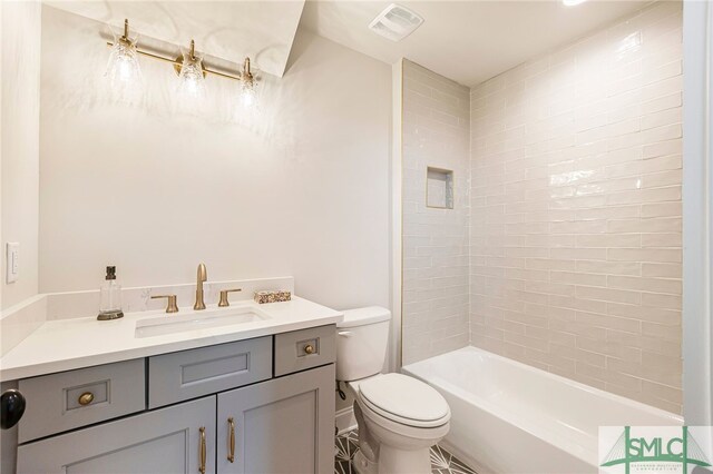 full bathroom with vanity, toilet, and tiled shower / bath