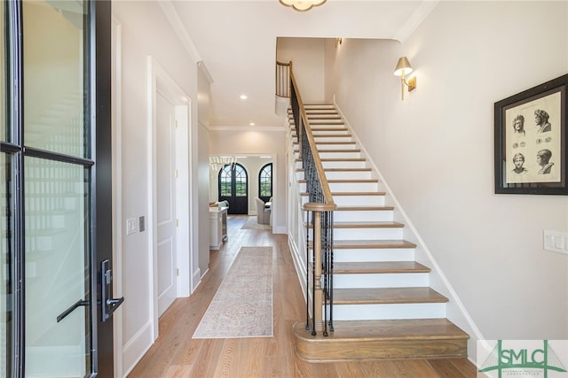 interior space featuring crown molding, french doors, and light hardwood / wood-style flooring