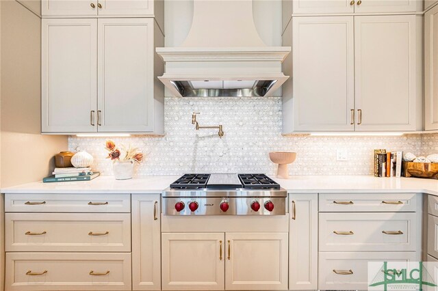 kitchen featuring tasteful backsplash, stainless steel gas stovetop, and custom exhaust hood