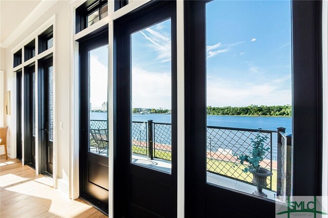 entryway featuring a water view and hardwood / wood-style floors