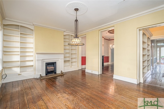 unfurnished living room featuring crown molding and hardwood / wood-style floors