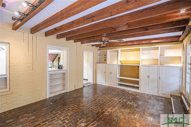 empty room featuring ceiling fan and beam ceiling