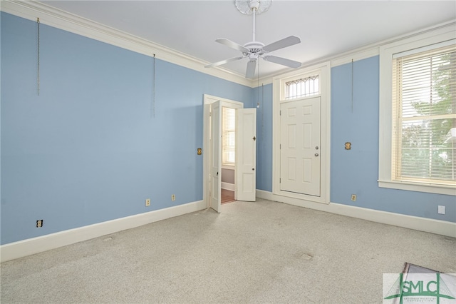 unfurnished room with ceiling fan and crown molding