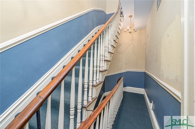 stairway featuring carpet