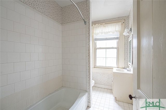 full bathroom with tile patterned floors, tiled shower / bath, toilet, and vanity