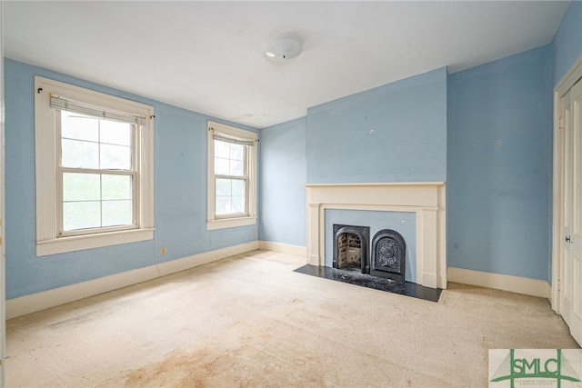 unfurnished living room with light colored carpet