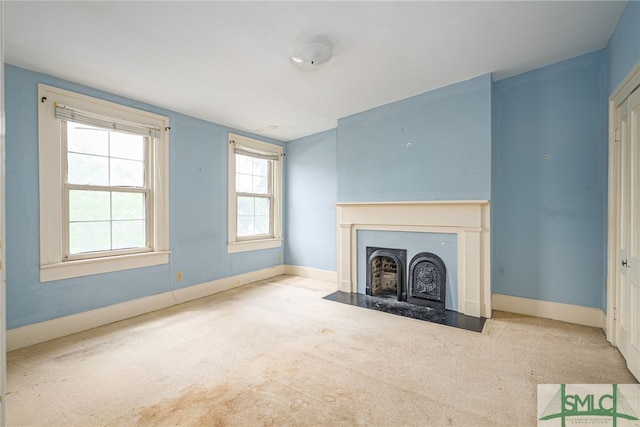 115 W Gordon St, Savannah, GA 31401 - unfurnished living room featuring a fireplace with flush hearth, carpet floors, and baseboards