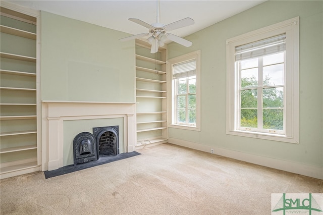 unfurnished living room featuring ceiling fan and light carpet