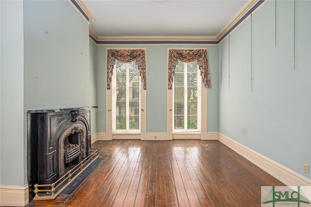 unfurnished living room with dark hardwood / wood-style floors and crown molding