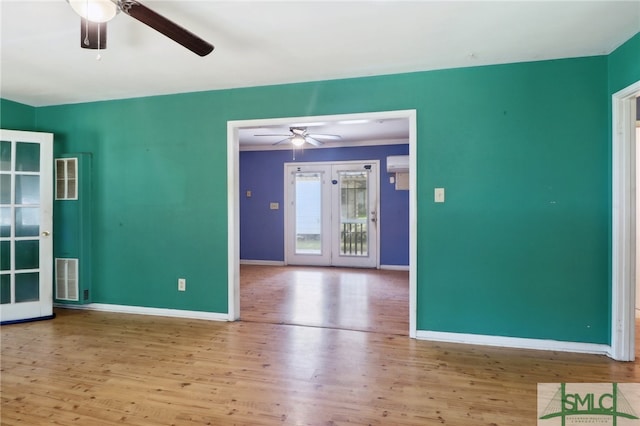 unfurnished room featuring light hardwood / wood-style flooring, an AC wall unit, and ceiling fan