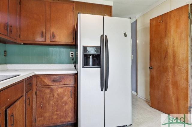 kitchen featuring white fridge with ice dispenser