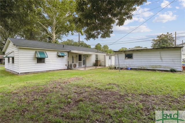 back of property featuring a yard