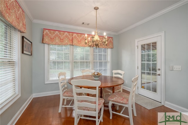 dining room with hardwood / wood-style flooring, plenty of natural light, and crown molding