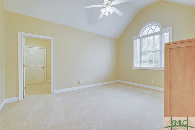 unfurnished bedroom with ceiling fan, light carpet, and vaulted ceiling