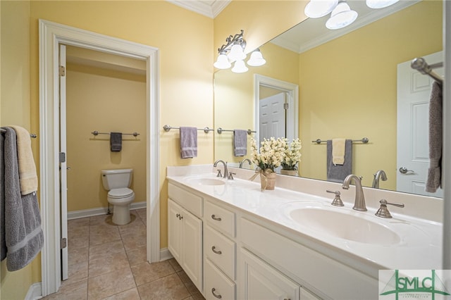 bathroom with tile patterned flooring, vanity, toilet, and crown molding