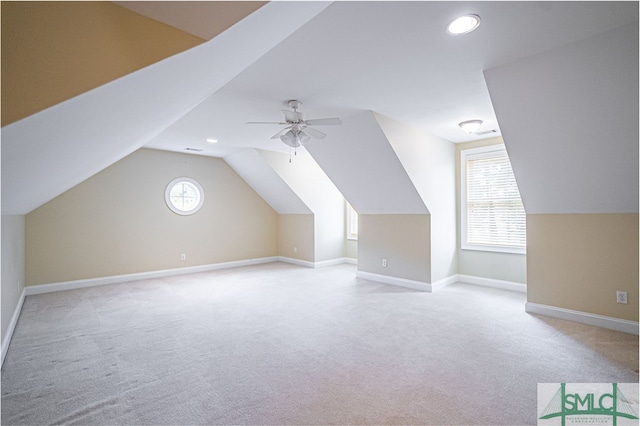 bonus room featuring a wealth of natural light, ceiling fan, light colored carpet, and vaulted ceiling