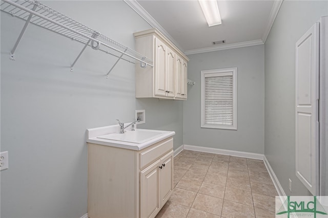 washroom featuring cabinets, crown molding, sink, washer hookup, and light tile patterned flooring