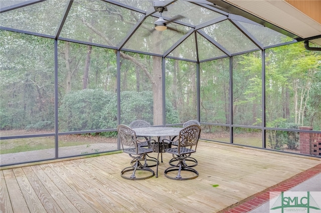 unfurnished sunroom with ceiling fan