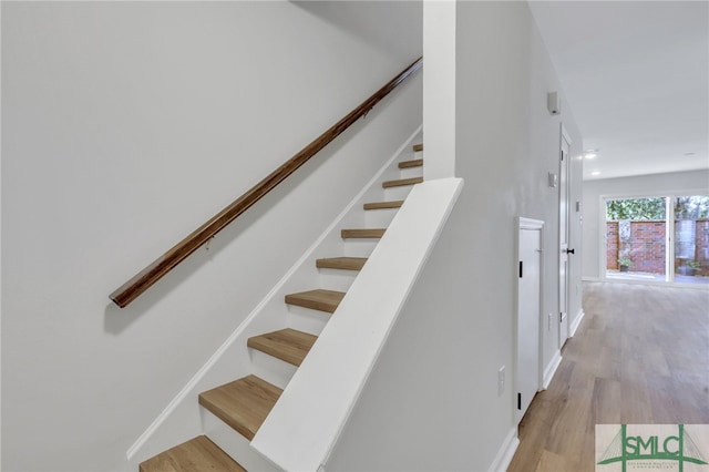 stairs featuring wood-type flooring