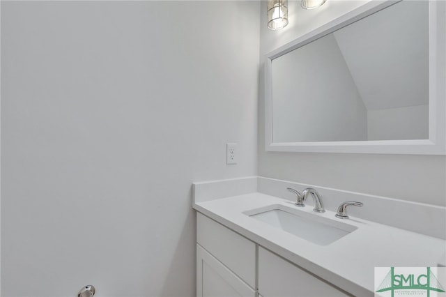 bathroom with vanity and vaulted ceiling