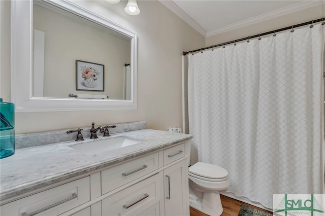 bathroom with hardwood / wood-style floors, crown molding, vanity, and toilet