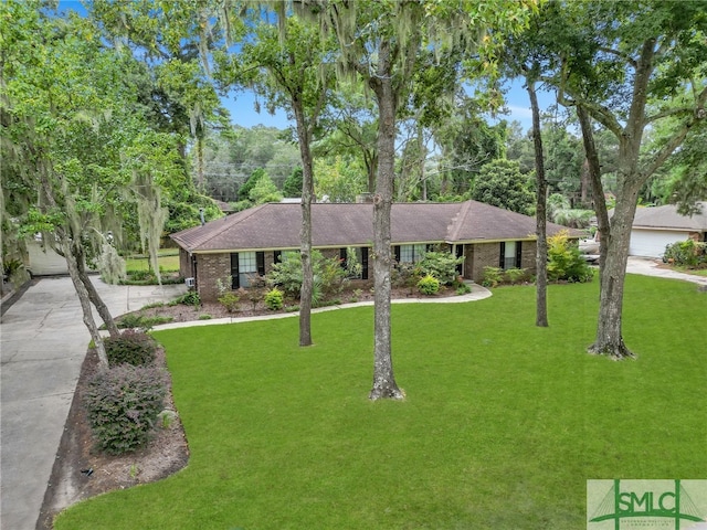 single story home featuring a front yard and a garage