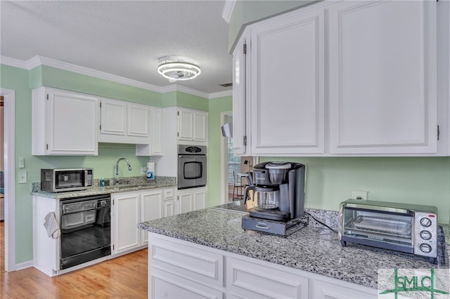 kitchen featuring crown molding, light stone countertops, stainless steel appliances, and white cabinets