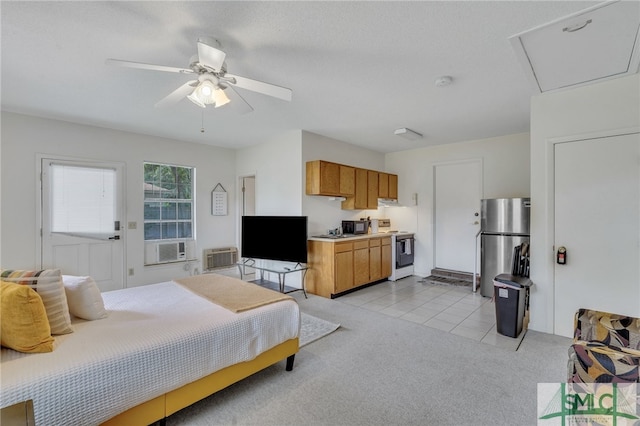 bedroom with light carpet, ceiling fan, and stainless steel refrigerator