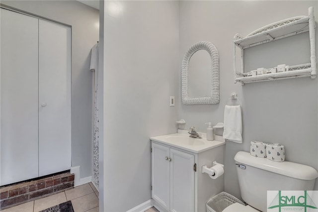 bathroom featuring vanity, toilet, and tile patterned floors