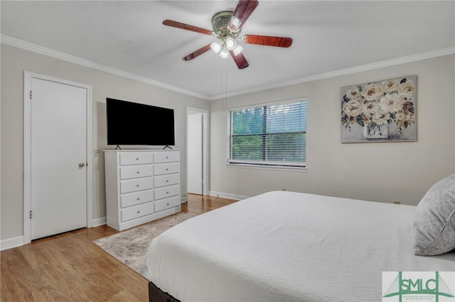 bedroom featuring ornamental molding, light hardwood / wood-style floors, ceiling fan, and a textured ceiling