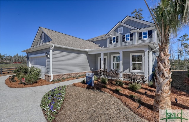 view of front facade with a garage and a porch