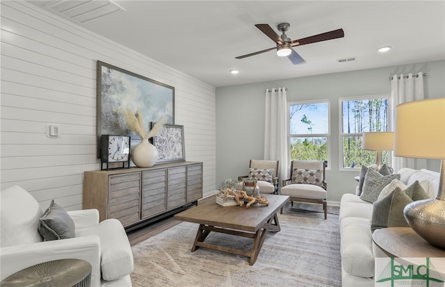 living room with ceiling fan and wood-type flooring