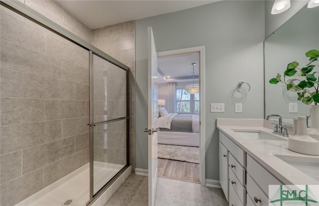 bathroom featuring vanity, tile patterned flooring, and an enclosed shower