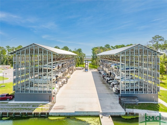 surrounding community with a boat dock and a water view