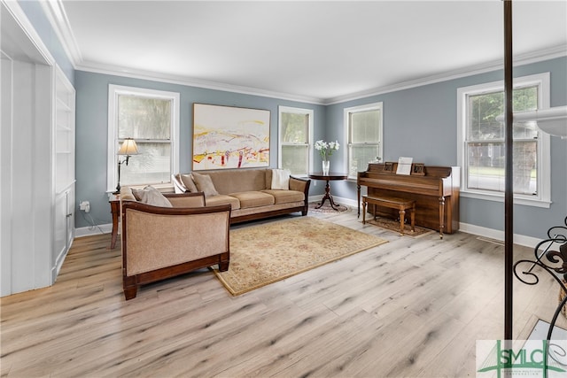 living room with light wood-type flooring and ornamental molding