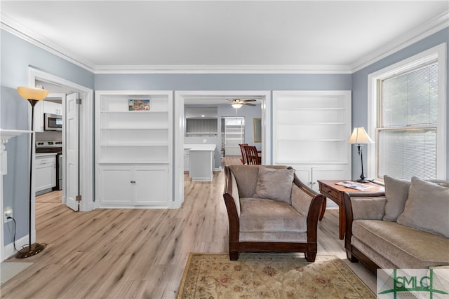 sitting room featuring light hardwood / wood-style floors, ceiling fan, and crown molding