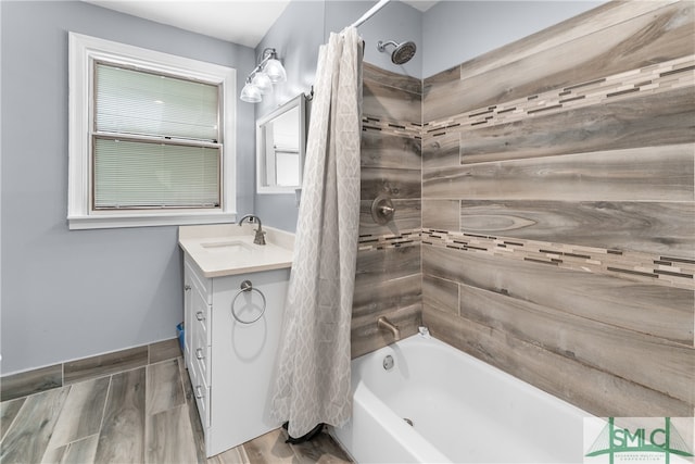 bathroom featuring wood-type flooring, vanity, and shower / bath combo