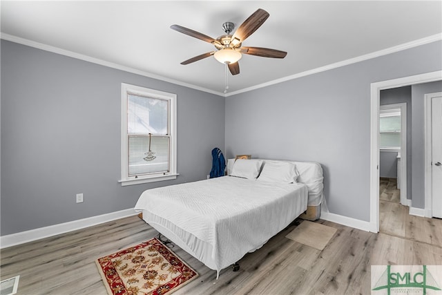 bedroom with light hardwood / wood-style floors, ceiling fan, and crown molding