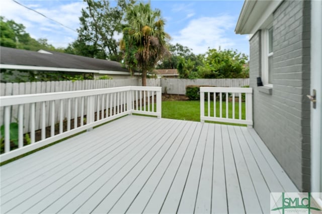 wooden terrace with a lawn