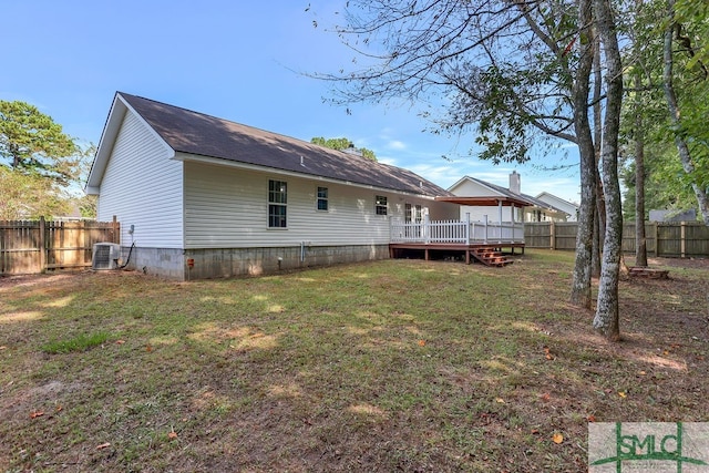 back of house with a lawn, a wooden deck, and cooling unit