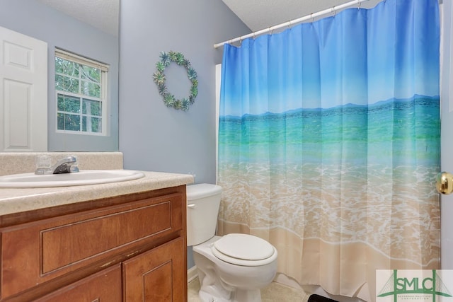 bathroom with vanity, toilet, a textured ceiling, and walk in shower