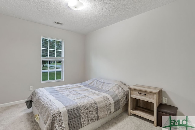 carpeted bedroom with a textured ceiling